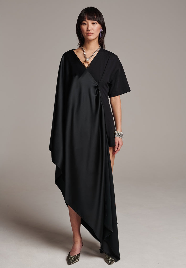 Elevate your wardrobe with this deconstructed dress. Features a v-neckline, dropped shoulders, and an asymmetric detail.