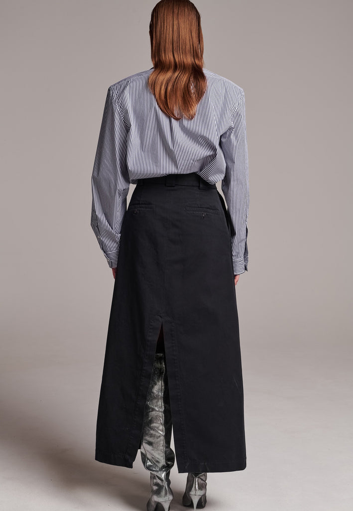 A deconstructed chino skirt featuring prominent front and back slits which create effortless movement within every step. Features pockets and big belt loops.