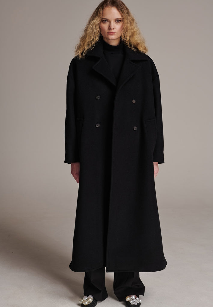 This long, oversized coat is crafted from a luxurious cashmere-wool blend, designed to keep you both warm and stylish. Don’t miss the interior pocket finished with our couture zipper, and the ‘We Should Kiss’ mantra inside, a reminder to embrace kindness. This coat offers a cool, sophisticated look, perfect for pairing with everything from evening dresses to denim, making it a versatile statement piece you’ll want to wear everywhere.