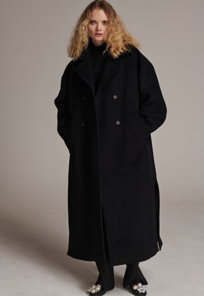 This long, oversized coat is crafted from a luxurious cashmere-wool blend, designed to keep you both warm and stylish. Don’t miss the interior pocket finished with our couture zipper, and the ‘We Should Kiss’ mantra inside, a reminder to embrace kindness. This coat offers a cool, sophisticated look, perfect for pairing with everything from evening dresses to denim, making it a versatile statement piece you’ll want to wear everywhere.