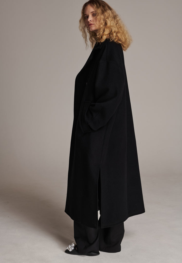 This long, oversized coat is crafted from a luxurious cashmere-wool blend, designed to keep you both warm and stylish. Don’t miss the interior pocket finished with our couture zipper, and the ‘We Should Kiss’ mantra inside, a reminder to embrace kindness. This coat offers a cool, sophisticated look, perfect for pairing with everything from evening dresses to denim, making it a versatile statement piece you’ll want to wear everywhere.