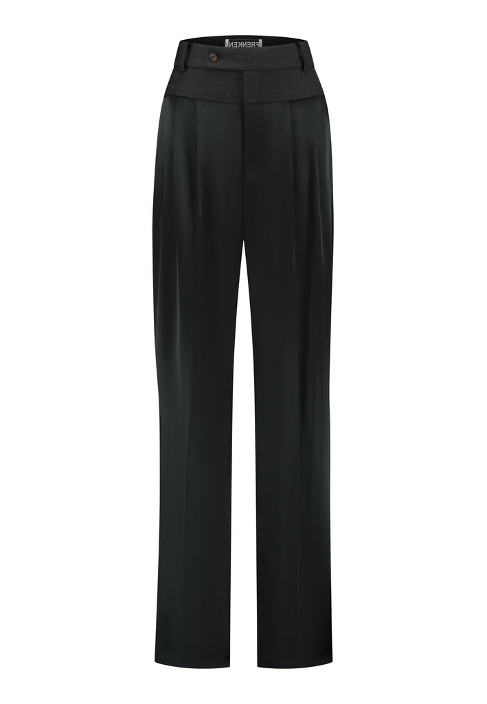 These deconstructed trousers combine a tailored wool top with a raw-edge finish, seamlessly attached to wide crepe satin legs that fall elegantly. The flat pleats create a slimmimg effect at the waist, enhancing the voluminous look of the wide legs. The pressed seam elongated the legs, ensuring a striking and sophisticated silhouette.