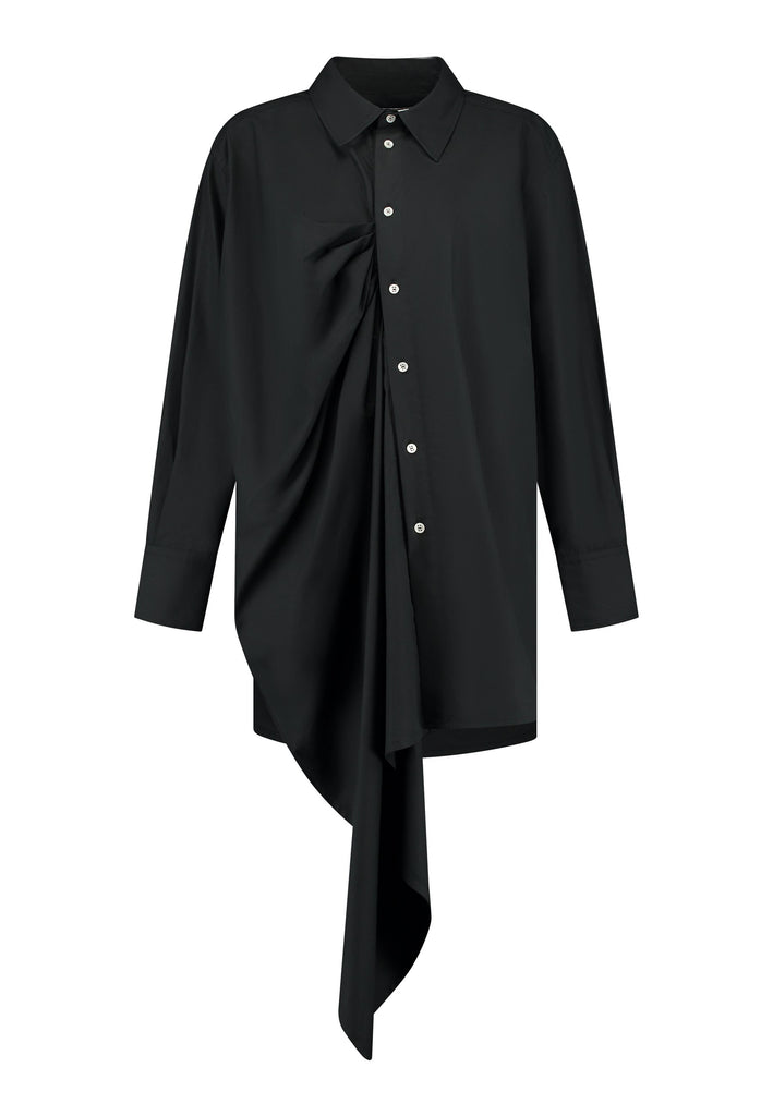 Oversized asymmetric shirt. Specially detailed with a long ruffle effect on one side. It has a button closure to adjust the neckline. 100% Cotton and with an oversized loose shape. Designed for a comfortable and unique fit. A timeless piece.