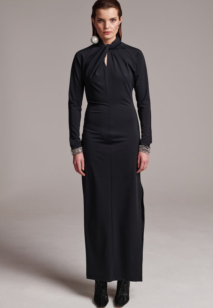 Embrace sleek sophistication with this body-hugging jersey maxi dress, designed for a smooth and comfortable fit. The artfully knotted neckline adds an elegant touch, while the body-skimming silhouette enhances your shape. Featuring a concealed side zipper that extends up to the armhole, this dress is ideal for formal occasions. For a more casual look, pair it with an oversized blazer to effortlessly transition from an evening event to a stylish daytime ensemble.