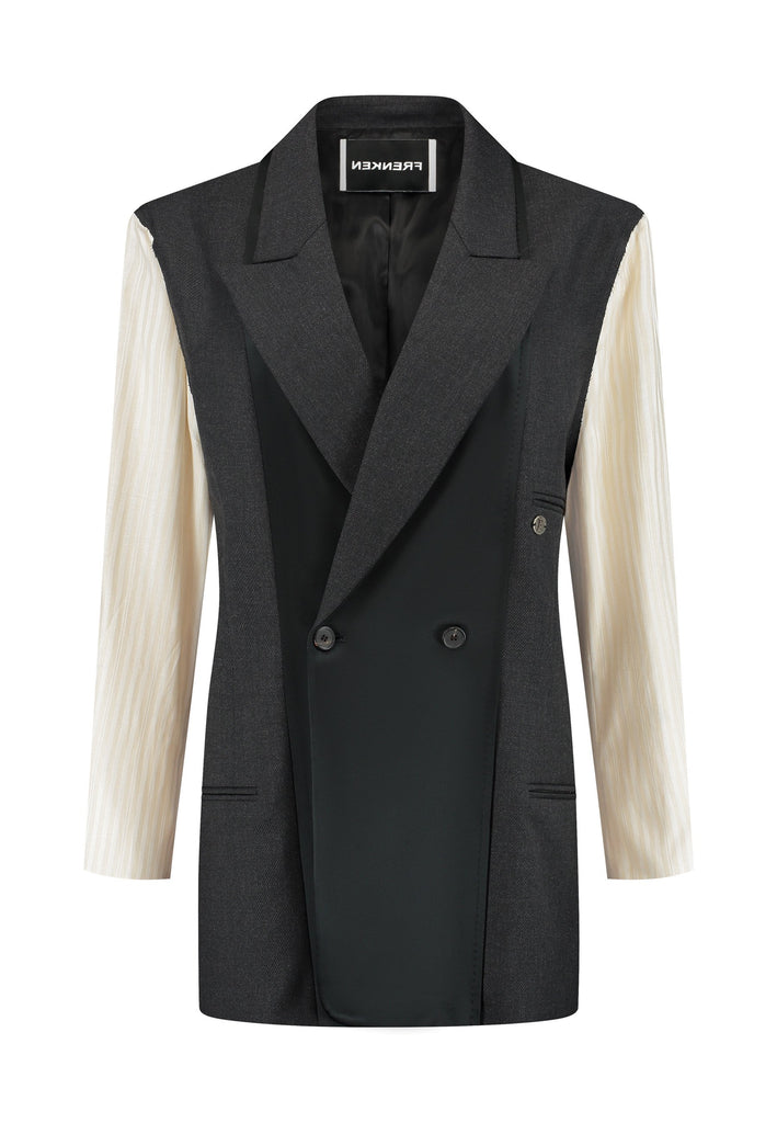 Perfectly tailored with a contemporary twist, this oversized blazer features unique inside-out details. The raw edge seam around the shoulder, where the tonal striped sleeve is set in, showcases its deconstructed design. Referencing the lining, the sleeve and welt pocket holds a charming Frenken lucky coin. A rounded insert at the back shoulder and refined darts enhance the sophisticated silhouette. Broad, soft shoulders, double-breasted horn buttons, and a fully satin-lined interior complete this standout 