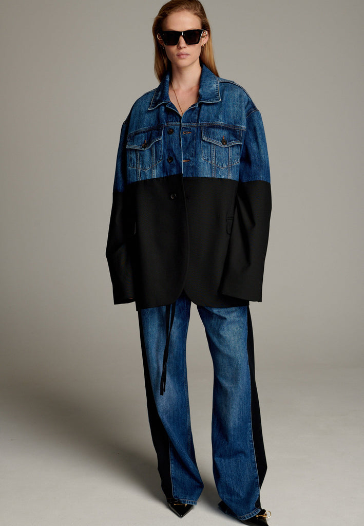 This unique jacket combines two timeless styles into one bold statement piece. The upper half showcases classic blue denim with a casual, relaxed vibe, while the bottom half transitions seamlessly into a sleek black blazer for a polished, tailored look. The contrast between the two halves creates a striking visual effect, blending casual and formal elements effortlessly.