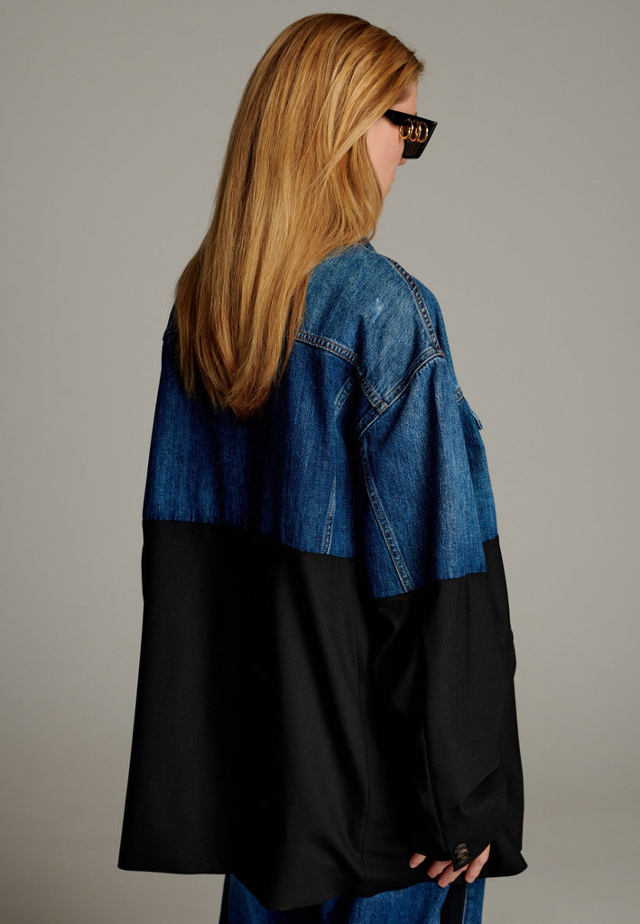 This unique jacket combines two timeless styles into one bold statement piece. The upper half showcases classic blue denim with a casual, relaxed vibe, while the bottom half transitions seamlessly into a sleek black blazer for a polished, tailored look. The contrast between the two halves creates a striking visual effect, blending casual and formal elements effortlessly.