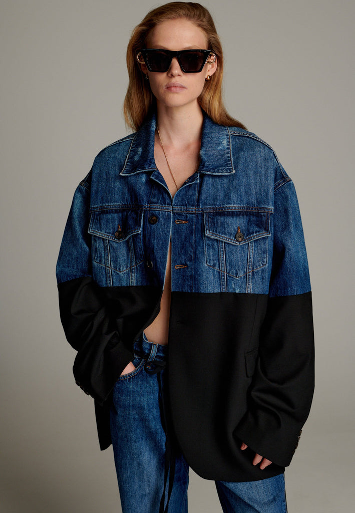 This unique jacket combines two timeless styles into one bold statement piece. The upper half showcases classic blue denim with a casual, relaxed vibe, while the bottom half transitions seamlessly into a sleek black blazer for a polished, tailored look. The contrast between the two halves creates a striking visual effect, blending casual and formal elements effortlessly.