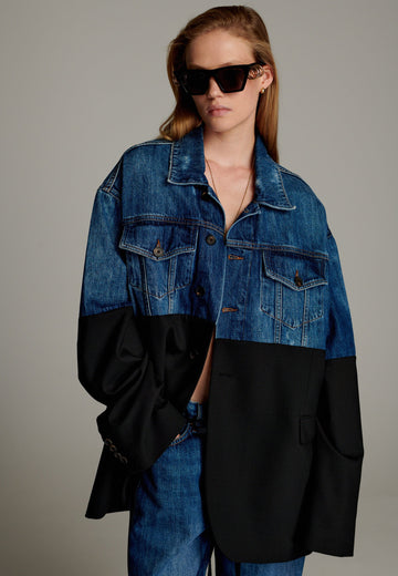 This unique jacket combines two timeless styles into one bold statement piece. The upper half showcases classic blue denim with a casual, relaxed vibe, while the bottom half transitions seamlessly into a sleek black blazer for a polished, tailored look. The contrast between the two halves creates a striking visual effect, blending casual and formal elements effortlessly.