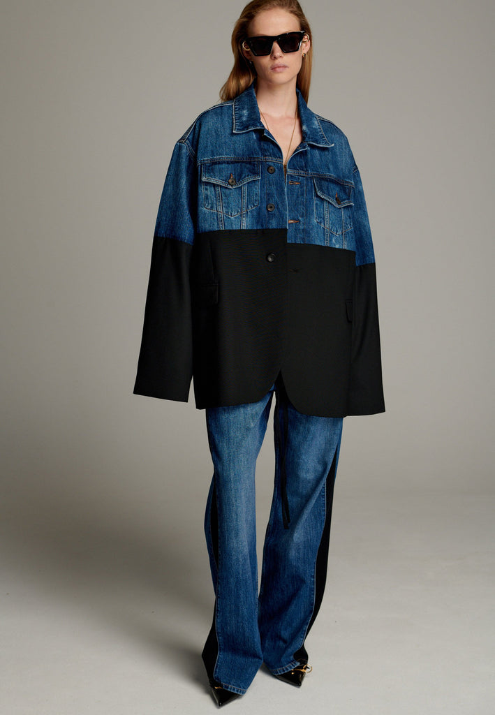 This unique jacket combines two timeless styles into one bold statement piece. The upper half showcases classic blue denim with a casual, relaxed vibe, while the bottom half transitions seamlessly into a sleek black blazer for a polished, tailored look. The contrast between the two halves creates a striking visual effect, blending casual and formal elements effortlessly.