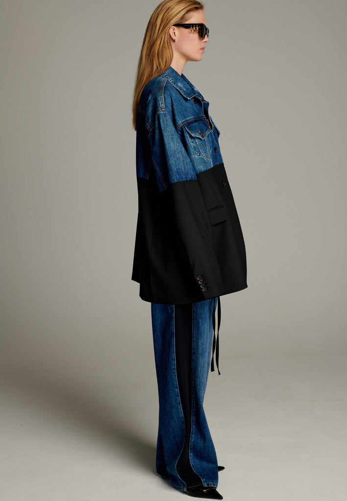 This unique jacket combines two timeless styles into one bold statement piece. The upper half showcases classic blue denim with a casual, relaxed vibe, while the bottom half transitions seamlessly into a sleek black blazer for a polished, tailored look. The contrast between the two halves creates a striking visual effect, blending casual and formal elements effortlessly.