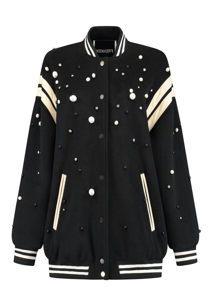 How cool is our oversized baseball jacket, finished with leather piping and adorned with faux pearls, meticulously hand-applied to create a stunning, galaxy-like effect. How would you wear it? Style it over a dress, pair it with a sleek tailored pant, or go for a bold look with oversized jeans. The possibilities are endless with this standout piece.