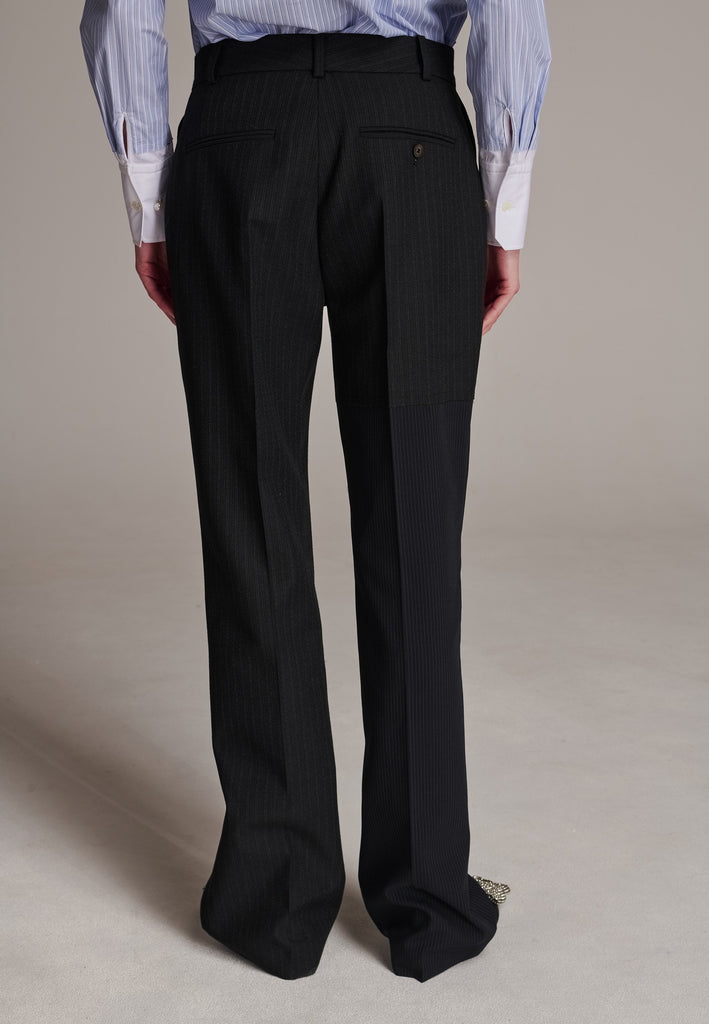 This straight-fitted pant, inspired by a masculine fit, features a subtle surprise: one leg crafted from a different fabric, noticeable only to the discerning eye. These trousers elongate the legs and can be worn as part of a sharp, complete suit. Style them casually with a T-shirt or an oversized shirt with rolled-up sleeves and an open front for a more relaxed, effortless look.