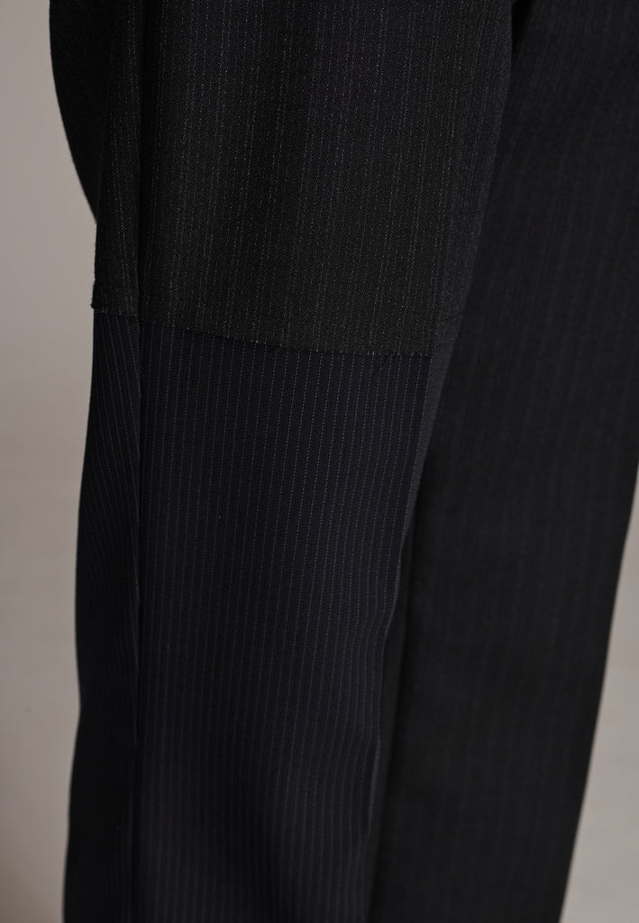 This straight-fitted pant, inspired by a masculine fit, features a subtle surprise: one leg crafted from a different fabric, noticeable only to the discerning eye. These trousers elongate the legs and can be worn as part of a sharp, complete suit. Style them casually with a T-shirt or an oversized shirt with rolled-up sleeves and an open front for a more relaxed, effortless look.