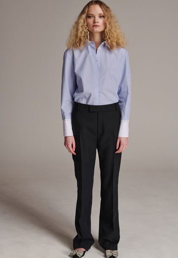 This straight-fitted pant, inspired by a masculine fit, features a subtle surprise: one leg crafted from a different fabric, noticeable only to the discerning eye. These trousers elongate the legs and can be worn as part of a sharp, complete suit. Style them casually with a T-shirt or an oversized shirt with rolled-up sleeves and an open front for a more relaxed, effortless look.