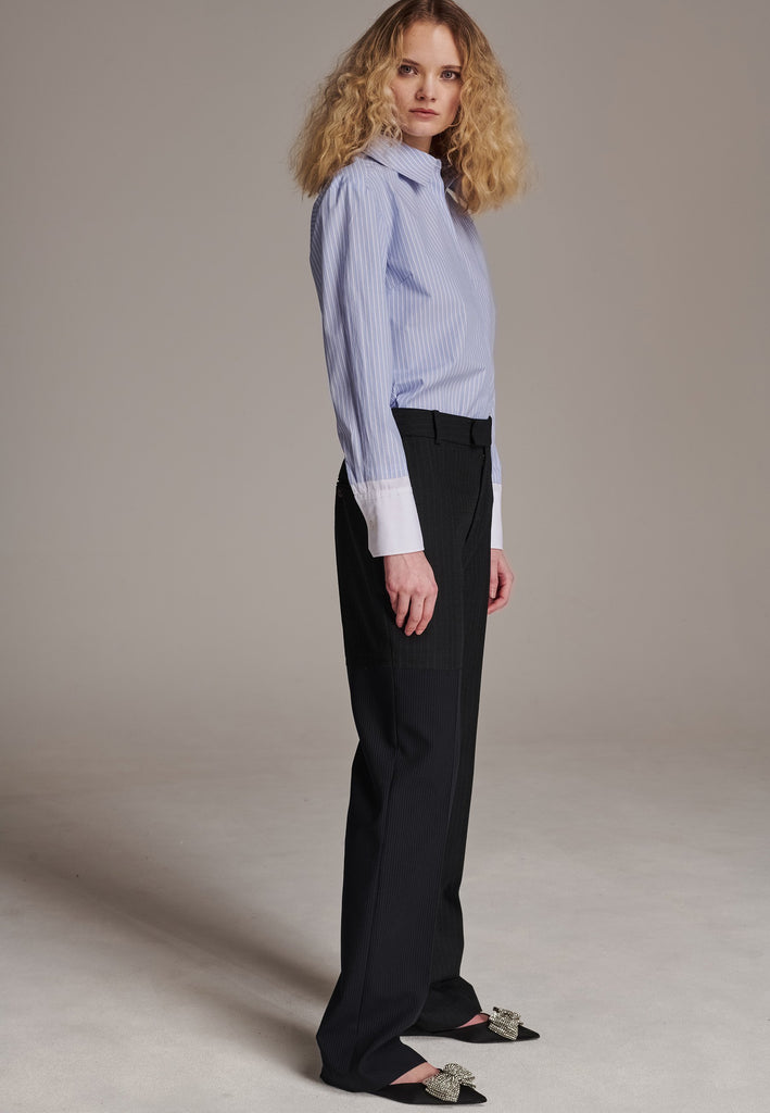 This straight-fitted pant, inspired by a masculine fit, features a subtle surprise: one leg crafted from a different fabric, noticeable only to the discerning eye. These trousers elongate the legs and can be worn as part of a sharp, complete suit. Style them casually with a T-shirt or an oversized shirt with rolled-up sleeves and an open front for a more relaxed, effortless look.