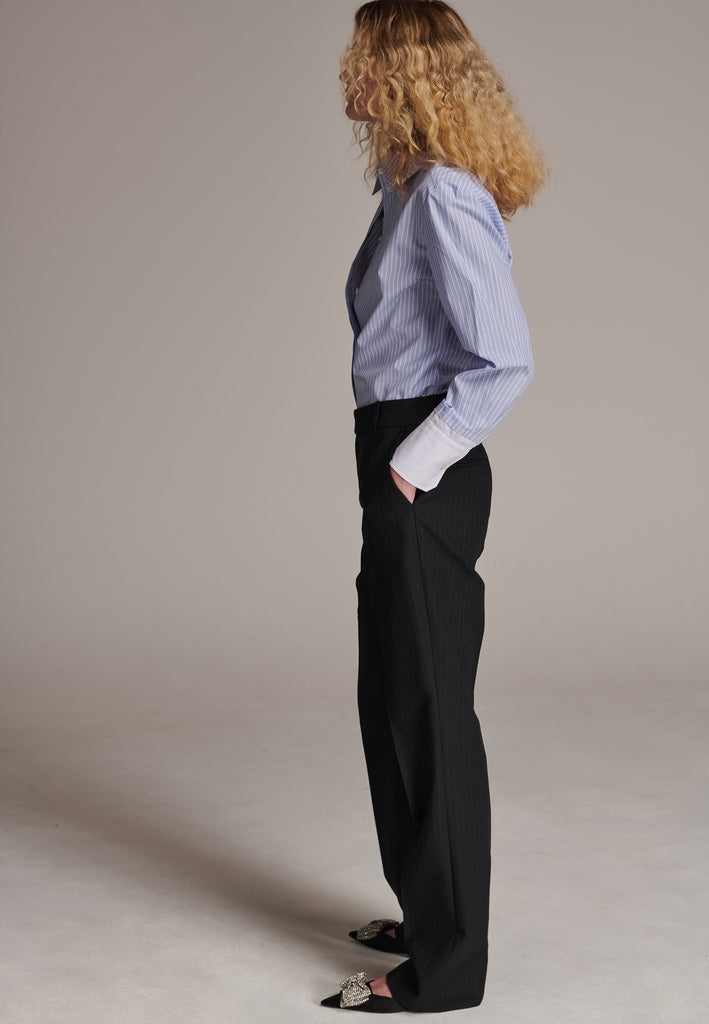 This straight-fitted pant, inspired by a masculine fit, features a subtle surprise: one leg crafted from a different fabric, noticeable only to the discerning eye. These trousers elongate the legs and can be worn as part of a sharp, complete suit. Style them casually with a T-shirt or an oversized shirt with rolled-up sleeves and an open front for a more relaxed, effortless look.