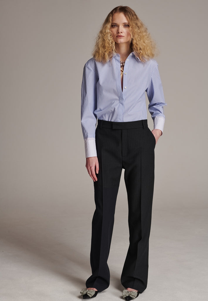 This straight-fitted pant, inspired by a masculine fit, features a subtle surprise: one leg crafted from a different fabric, noticeable only to the discerning eye. These trousers elongate the legs and can be worn as part of a sharp, complete suit. Style them casually with a T-shirt or an oversized shirt with rolled-up sleeves and an open front for a more relaxed, effortless look.