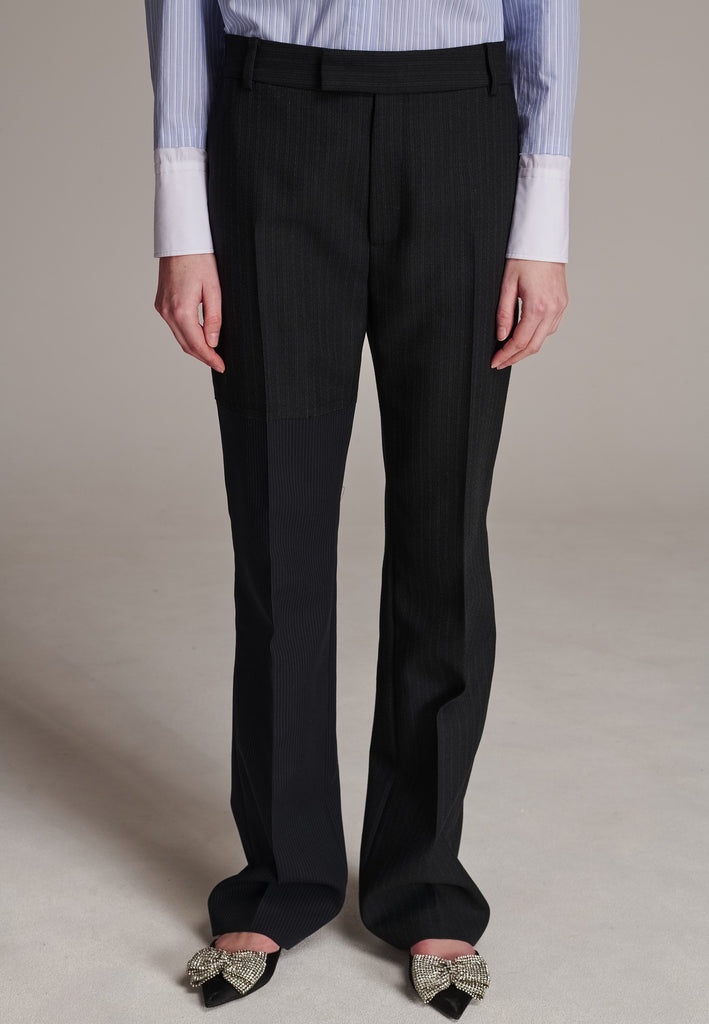 This straight-fitted pant, inspired by a masculine fit, features a subtle surprise: one leg crafted from a different fabric, noticeable only to the discerning eye. These trousers elongate the legs and can be worn as part of a sharp, complete suit. Style them casually with a T-shirt or an oversized shirt with rolled-up sleeves and an open front for a more relaxed, effortless look.