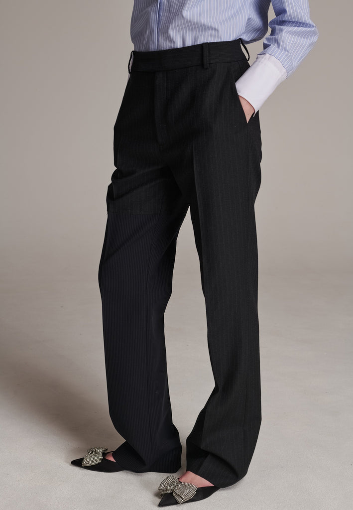 This straight-fitted pant, inspired by a masculine fit, features a subtle surprise: one leg crafted from a different fabric, noticeable only to the discerning eye. These trousers elongate the legs and can be worn as part of a sharp, complete suit. Style them casually with a T-shirt or an oversized shirt with rolled-up sleeves and an open front for a more relaxed, effortless look.