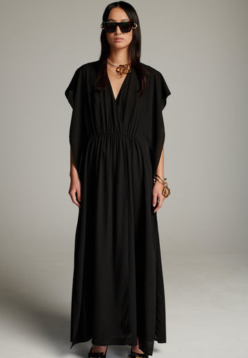 This dress features a flowing and elegant design in a black hue, crafted from lightweight silk georgette. The V-neckline and cinched waist create a flattering silhouette, while the loose, cape-like sleeves add a touch of modern sophistication. Perfect for both formal occasions and chic casual settings, it exudes timeless elegance and versatility.