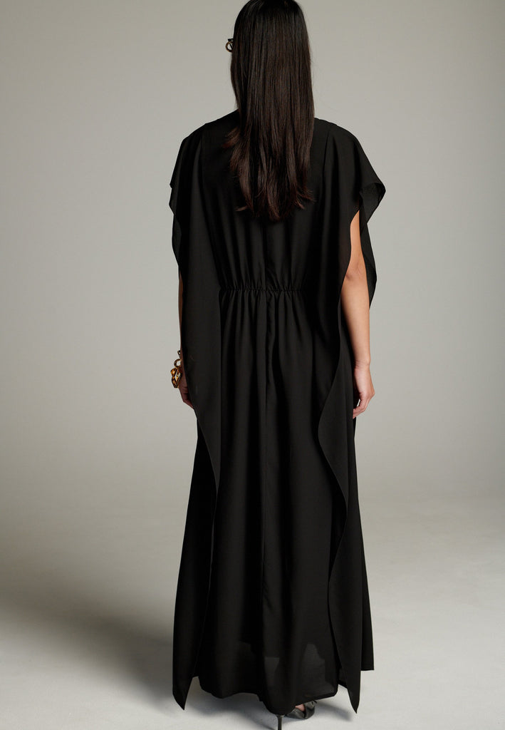 This dress features a flowing and elegant design in a black hue, crafted from lightweight silk georgette. The V-neckline and cinched waist create a flattering silhouette, while the loose, cape-like sleeves add a touch of modern sophistication. Perfect for both formal occasions and chic casual settings, it exudes timeless elegance and versatility.