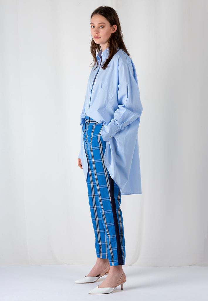 Double Placket | Shirt | Light Blue. Crispy poplin oversized shirt front panel smaller then back panel to give coverage in back and shape in front. Detailed with a double placket.