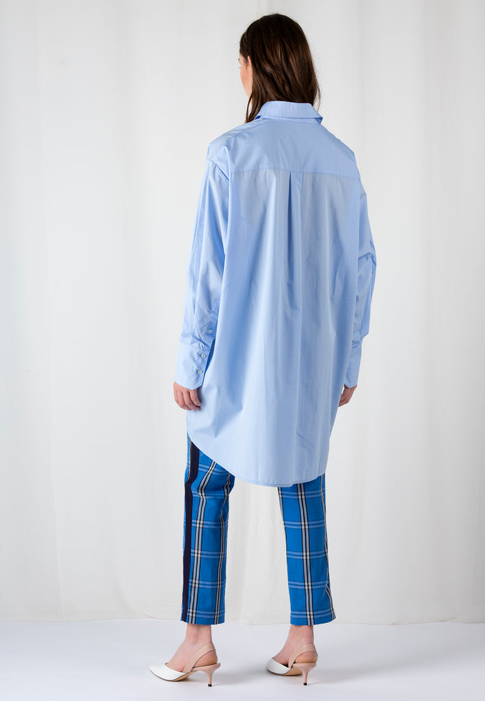 Double Placket | Shirt | Light Blue. Crispy poplin oversized shirt front panel smaller then back panel to give coverage in back and shape in front. Detailed with a double placket.