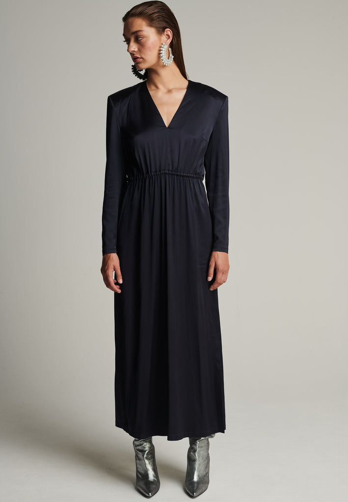 Shoulder-padded satin slim dress in navy. Features a v-neck, back and leg openings, and an elastic waistband. True to size.