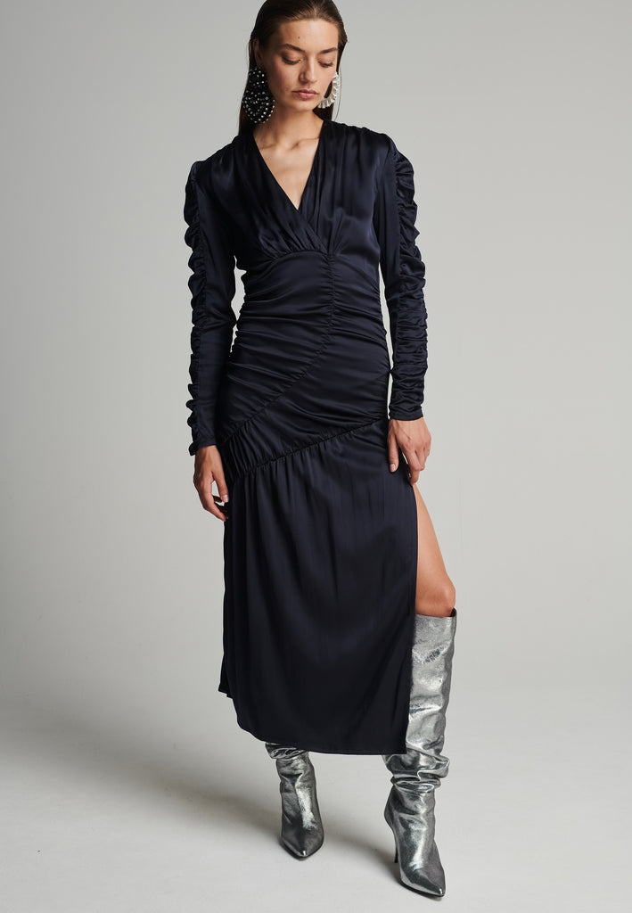 Satin midi dress in navy. Features a v-neck, wrinkled-style hip and arms, and leg opening. True to size.