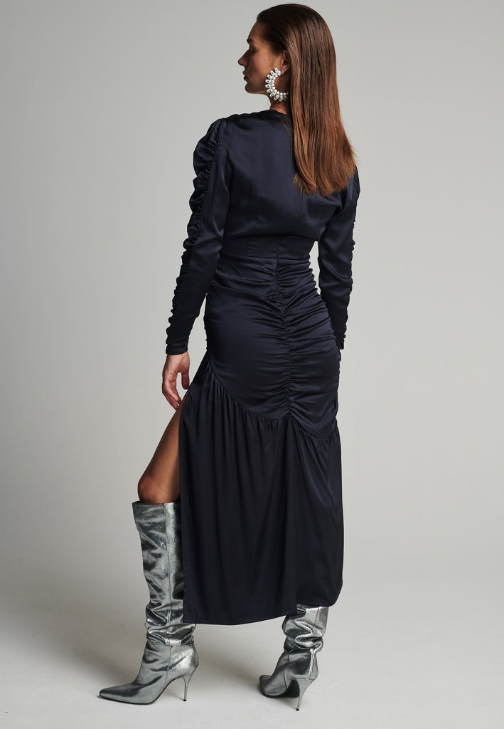 Satin midi dress in navy. Features a v-neck, wrinkled-style hip and arms, and leg opening. True to size.